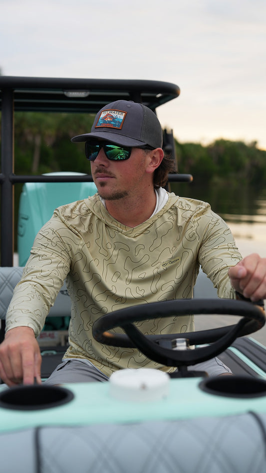 Wet Water Nature Coast Hoodie worn by an angler driving a boat