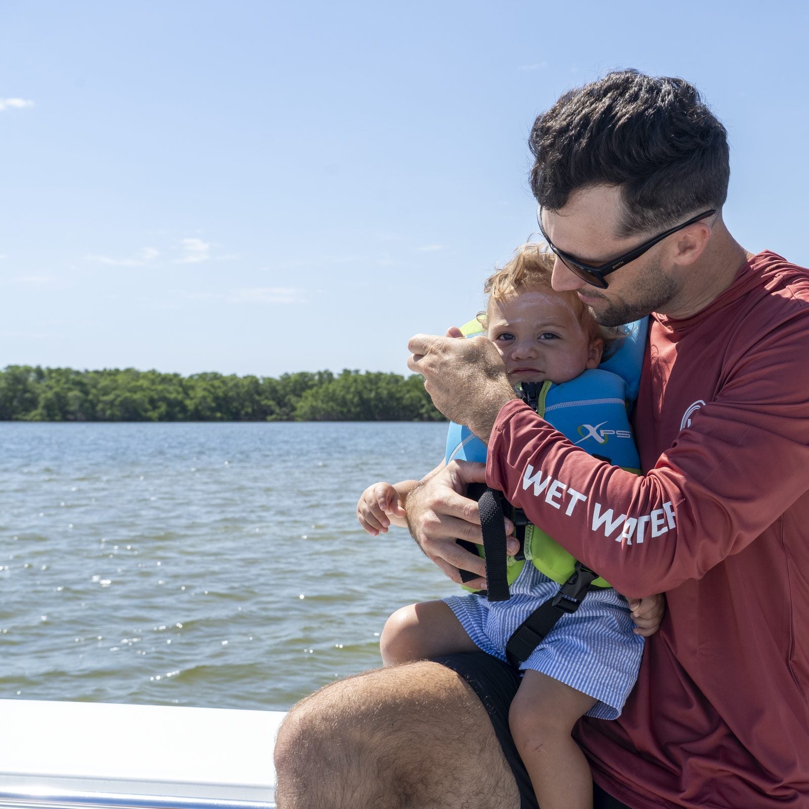 Wet Water Core Tide Performance Hoodie — a dad and his child on the boat